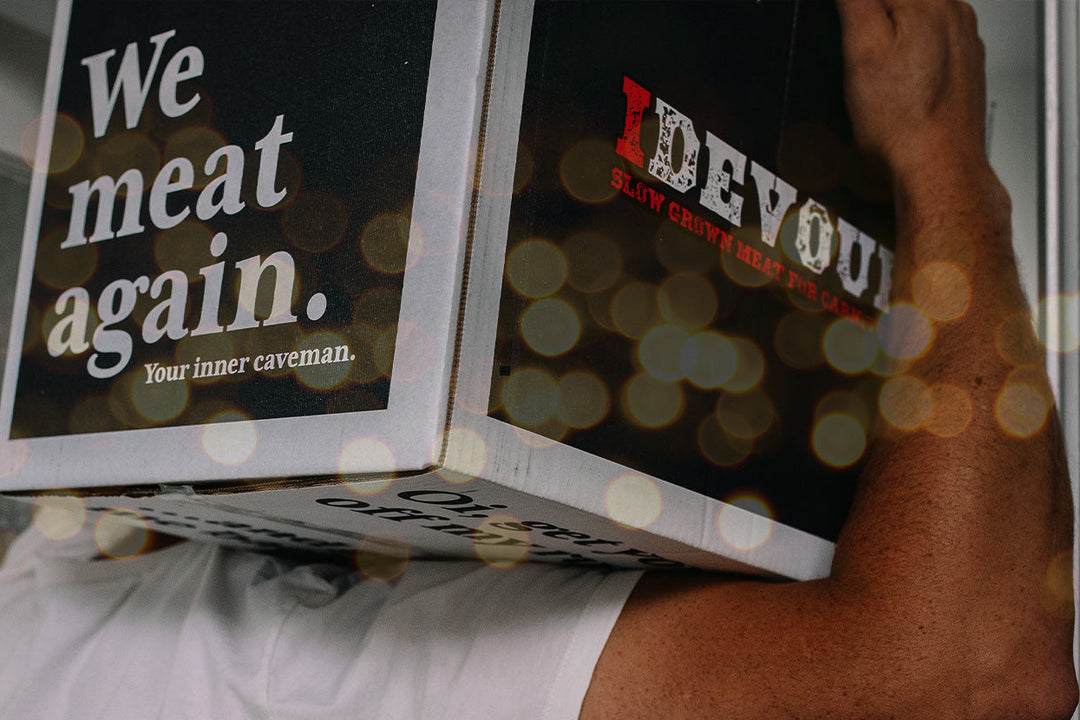 Man carrying box of idevour beef on his shoulder